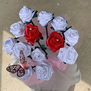 red and white roses decorated with pearls and a butterfly